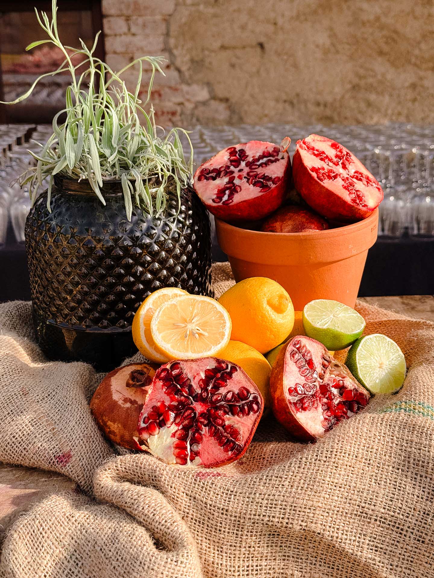 Still-life detail with pomegranates, citrus and greenery at the Villa Catignano wedding weekend.