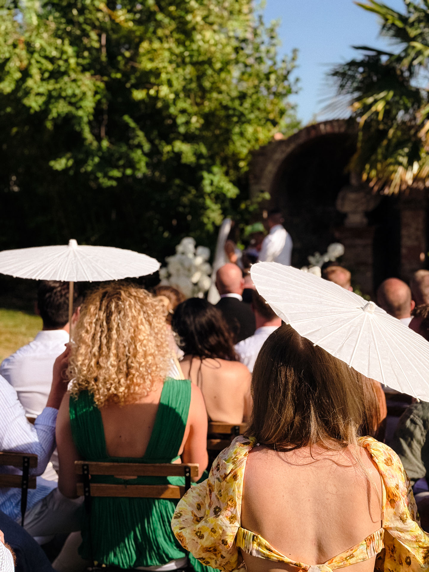 Outdoor wedding ceremony with guests seated in the gardens at Villa Catignano.
