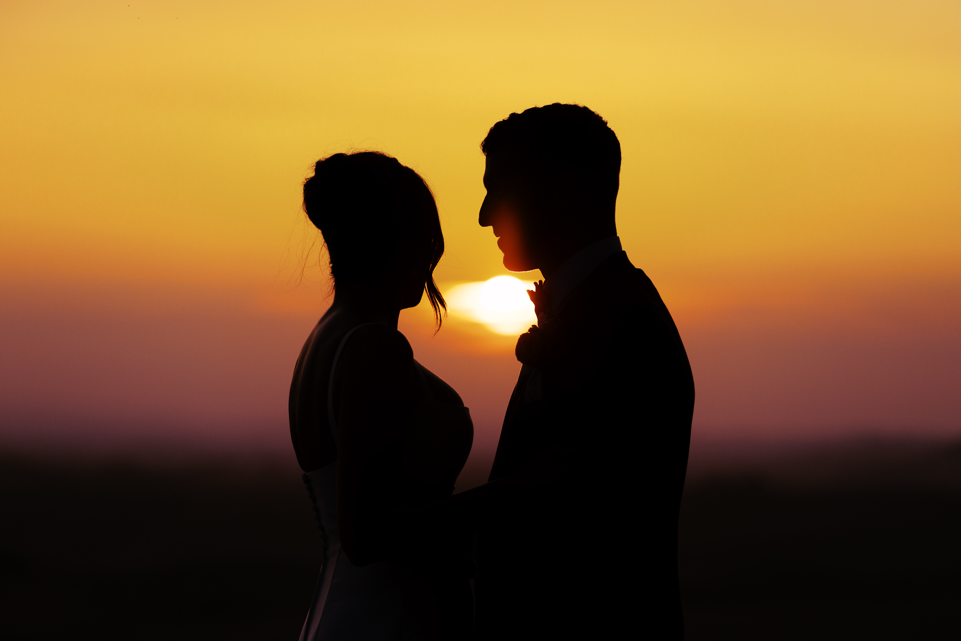 Nikita and Jason silhouetted against the setting sun