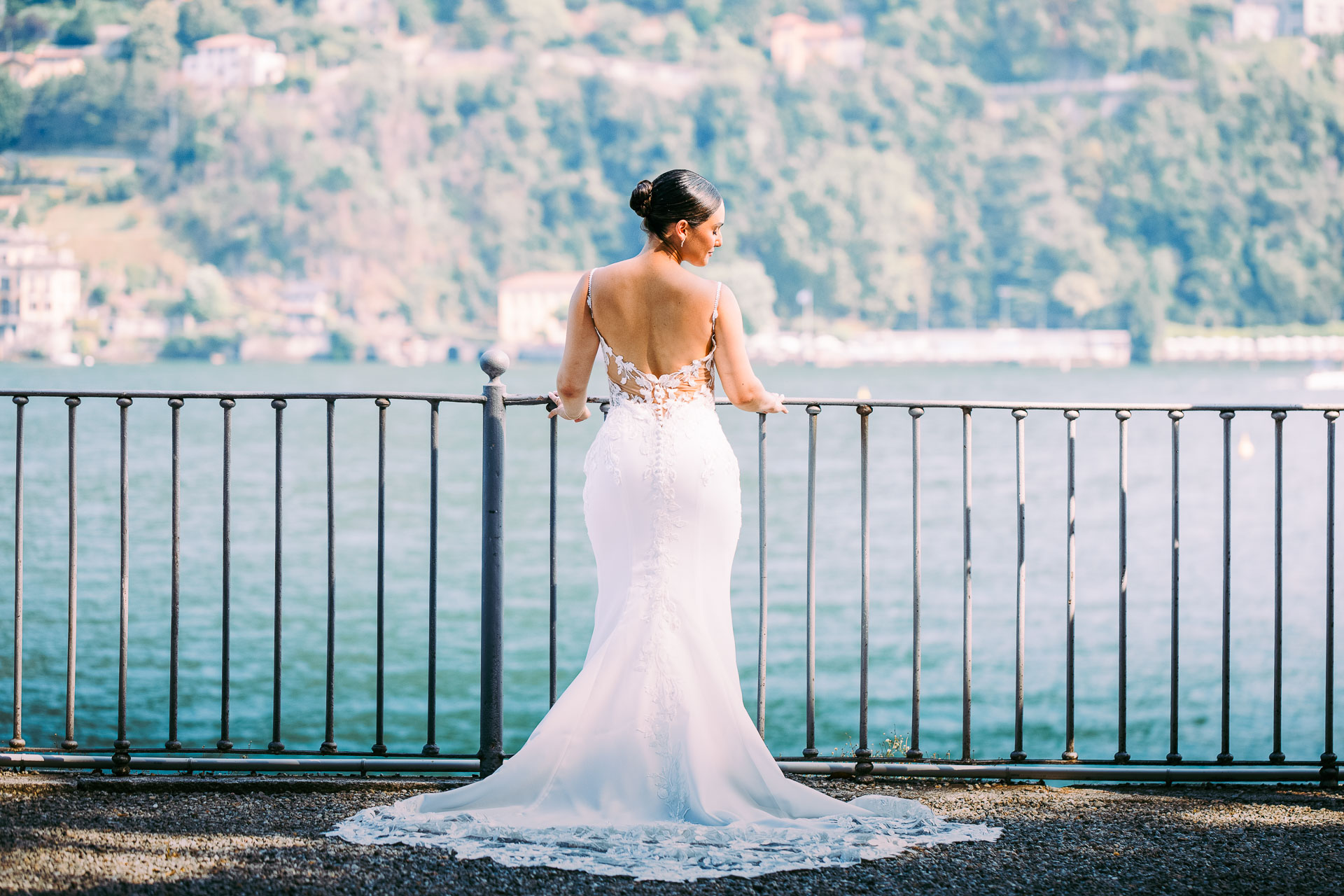 Victoria in her wedding dress beside the blue water of Lake Como