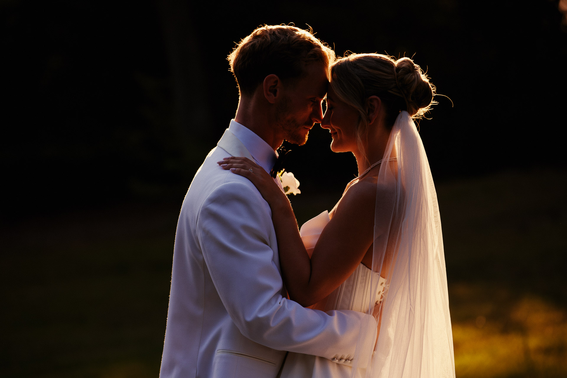 Ceri and Zach embrace in the golden evening light