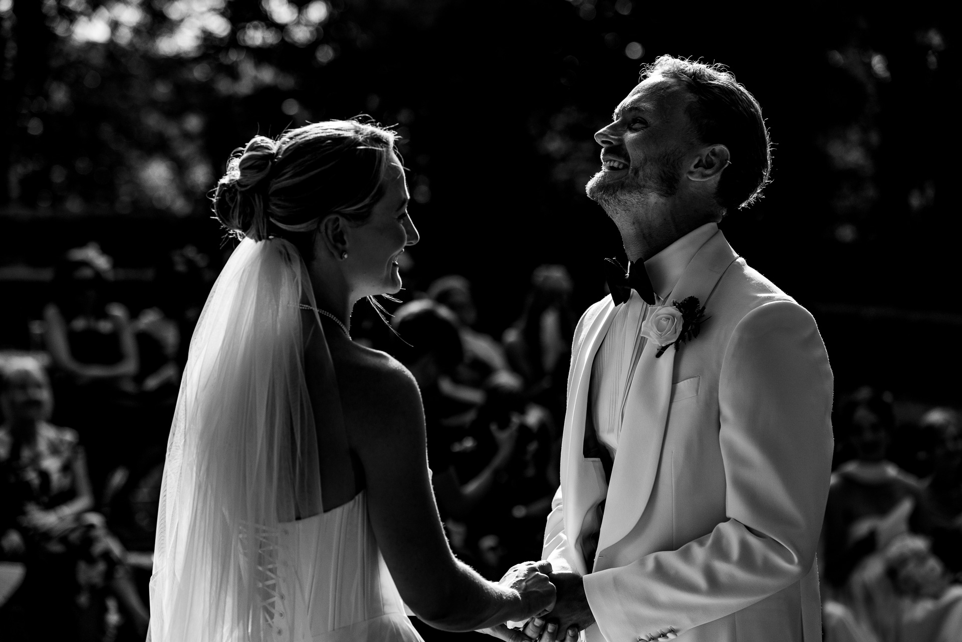 Ceri and Zach laugh together during their outdoor ceremony