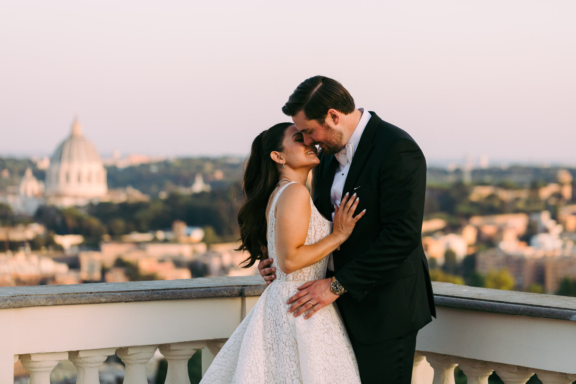 John and Christina embrace on a terrace overlooking Rome